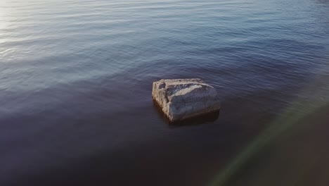 rock, big boulder in a water with blue waves and