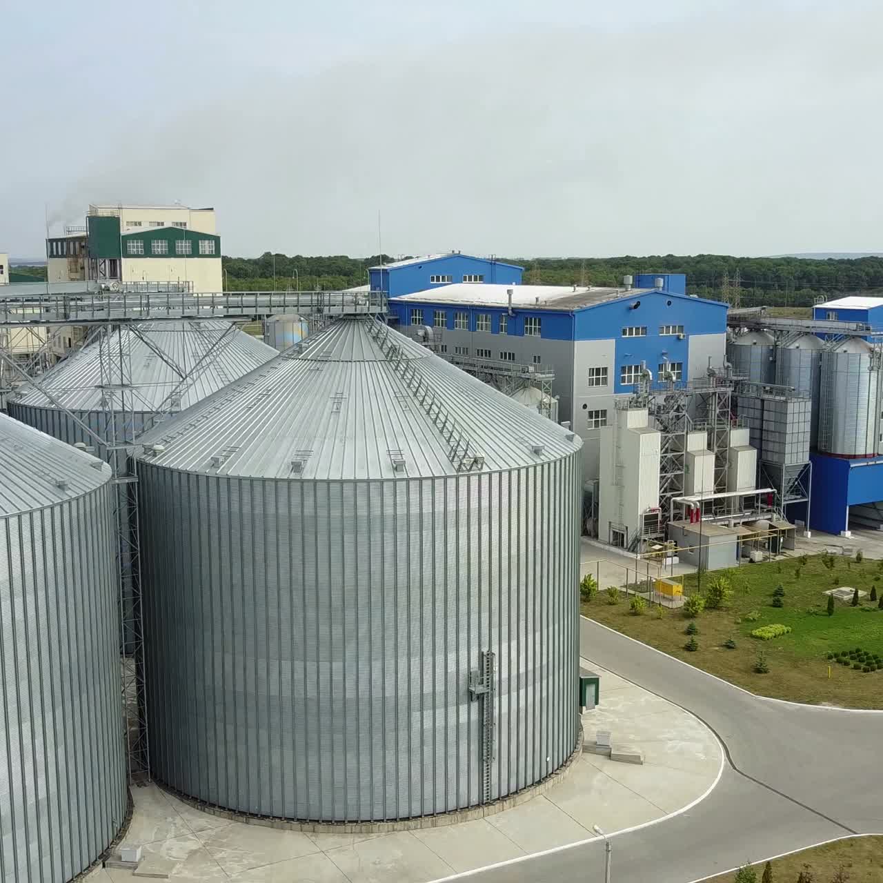 Aerial view of metal grain elevator in agricultural zone. Grain warehouse