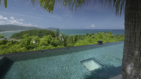 swimming pool at luxury resort with sea and mountains in phuket, thailand. 4k panning shot