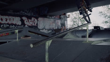 active teenagers having fun at skate spot. bmx rider making a tricks.