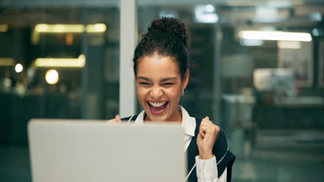 woman laughing at laptop