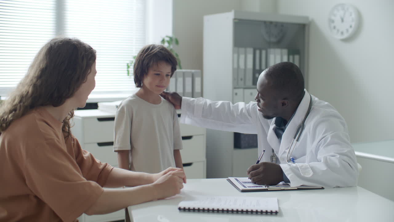 Pediatrician Providing Supportive Consultation to Young Boy and His Mother