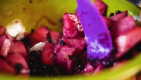 close up mixing sugar with fruit for a pie filling