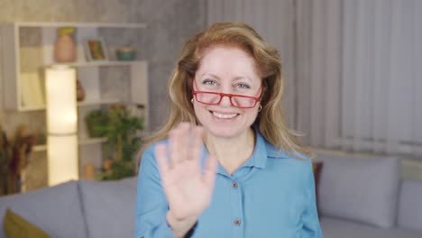 Elderly-woman-waving-cutely-looking-at-camera.