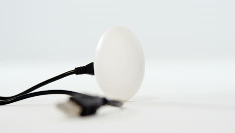 Chord-connected-to-easter-eggs-on-white-background