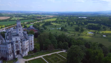 Dramatic-aerial-top-view-flight-Hluboká-Nad-Vltavou-is-a-Fairy-tale-castle-in-Czech-Republic-Europe,-summer-day-2023