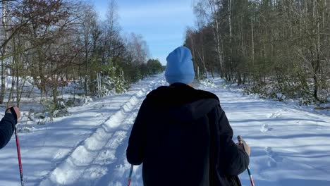 Woman-Skiing-On-The-Snowy-Slope-On-A-Sunny-Day-With-Trees-On-The-Background