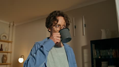 man drinking coffee at home