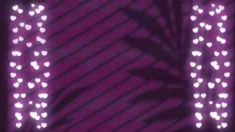 animation of hearts over leaves and window shadow on violet background