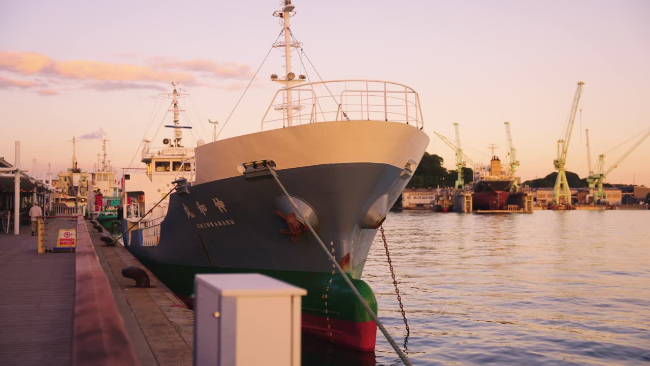 Slow pan at sunset over calm inland sea of Japan port