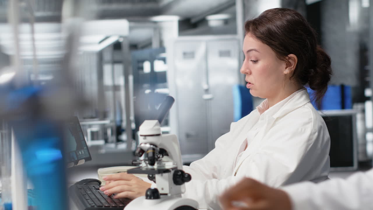 Vertical video Exhausted laboratory scientist rubbing eyes, tired at PC