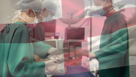 animation of flag of england over caucasian surgeons during surgery