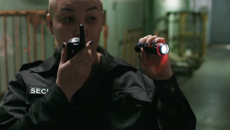 female safety guard with flashlight in a warehouse