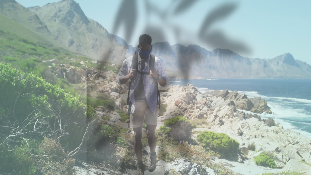 Hiking along rocky coastal path, man with animation of abstract shapes overlaying