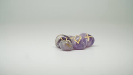 beautiful and expensive purple stones with yellow mark on the top of the table - close up shot