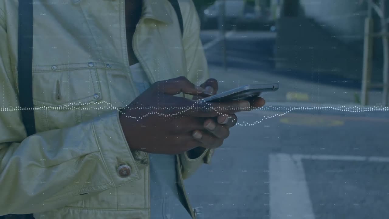 Statistical graphs against mid section of person using smartphone on the street