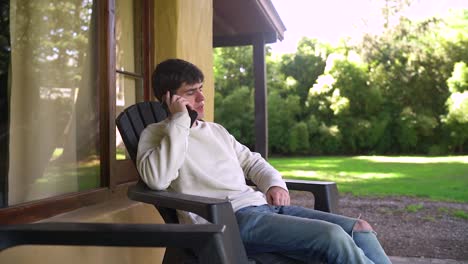 a boy sitting and talking on the phone - close up