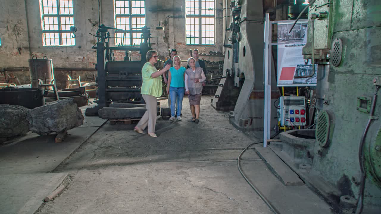 Family visiting the workshop of former Ravne ironworks. slow motion dolly out