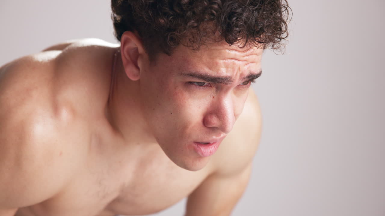 Close-up of Young Man Grimacing in Intense Pain