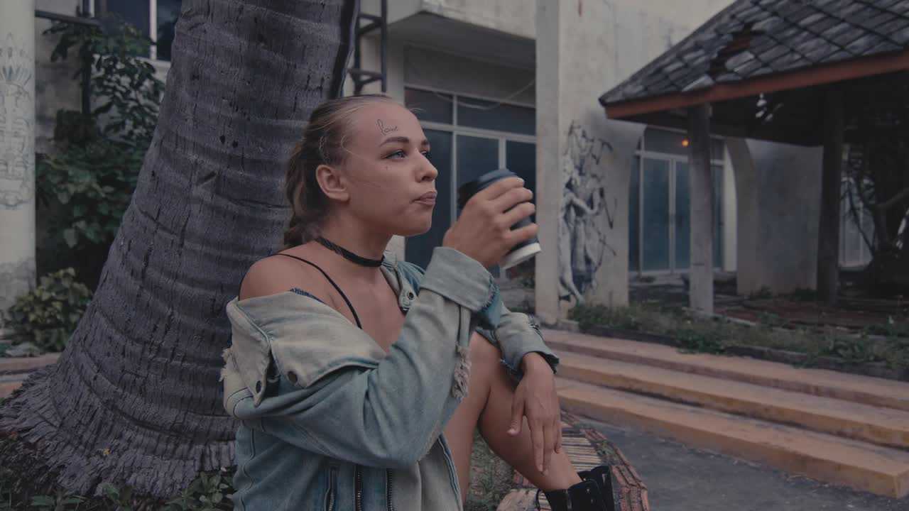 Woman Sitting Outside, Drinking Coffee