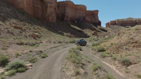 vehicle drive on the rough road along charyn canyon national park, kazakhstan, central asia