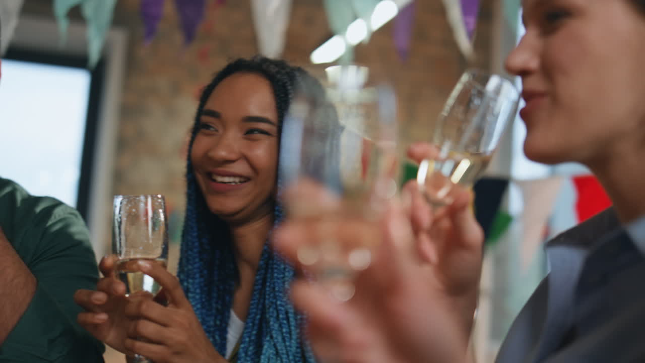 Multiracial people celebrating party in festive decorated room together close up
