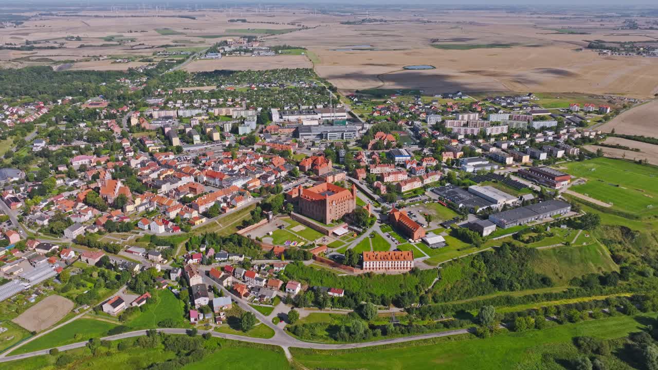 Aerial view of Gniew with medieval castle symbolizing resilience and community