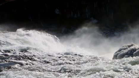 spray from a turbulent river being blown by strong gusty winds