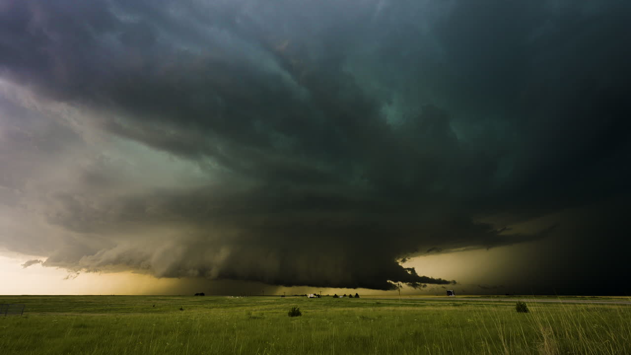 Incredible supercell thunderstorm spinning over a busy highway
