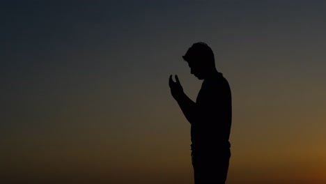 praying sunset silhouette