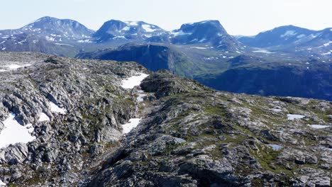 patches of snow in the summit of mount katthammaren norway - aerial shot