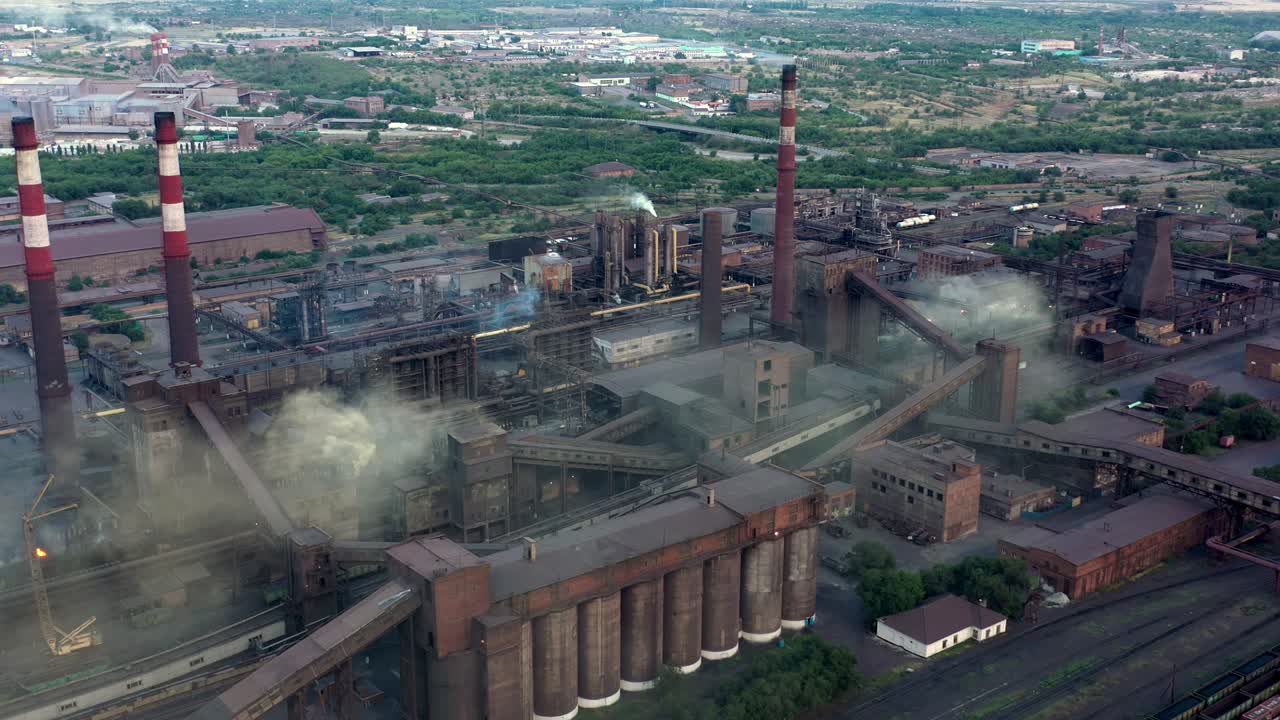 Industrial area fly over, drone shot of factory tubes and plants