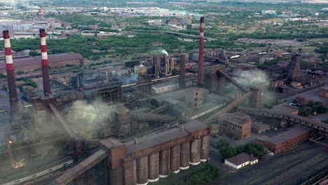 industrial area fly over, drone shot of factory tubes and plants