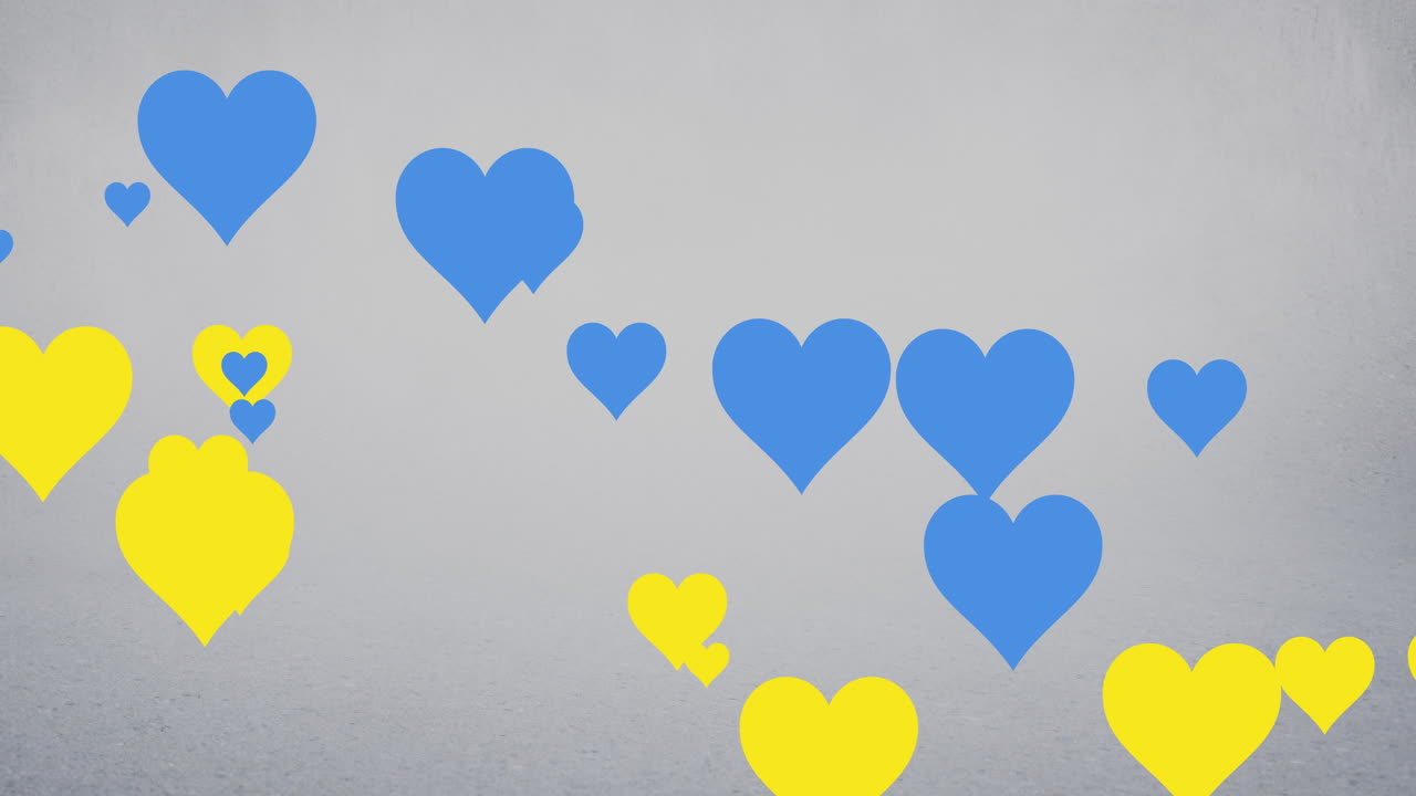 회색 배경 위에 떠다니는 파란색과 노란색 심장의 애니메이션