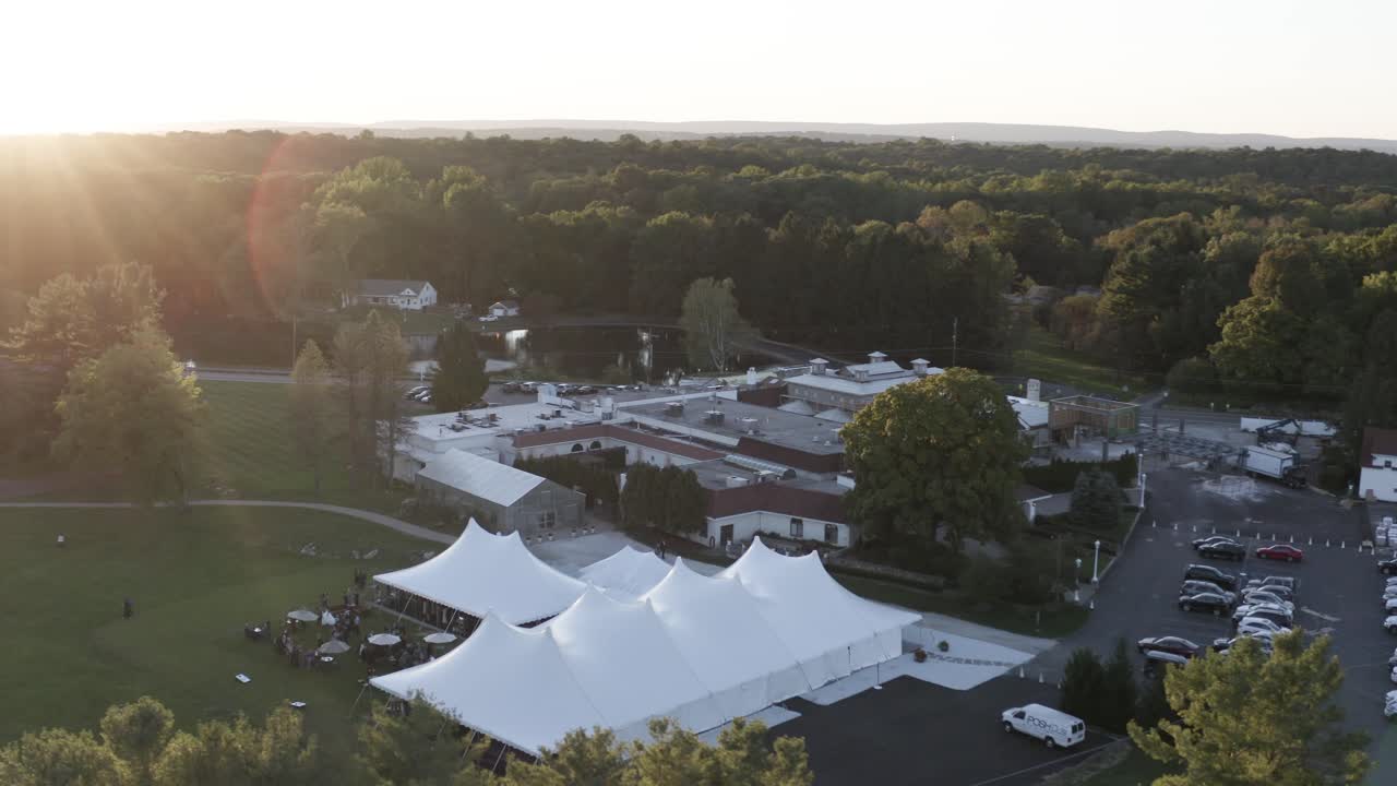 Wedding celebration in luxury white tent in aerial orbiting view