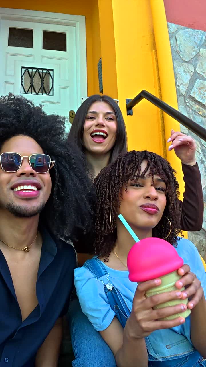 Group of people posing near a yellow building