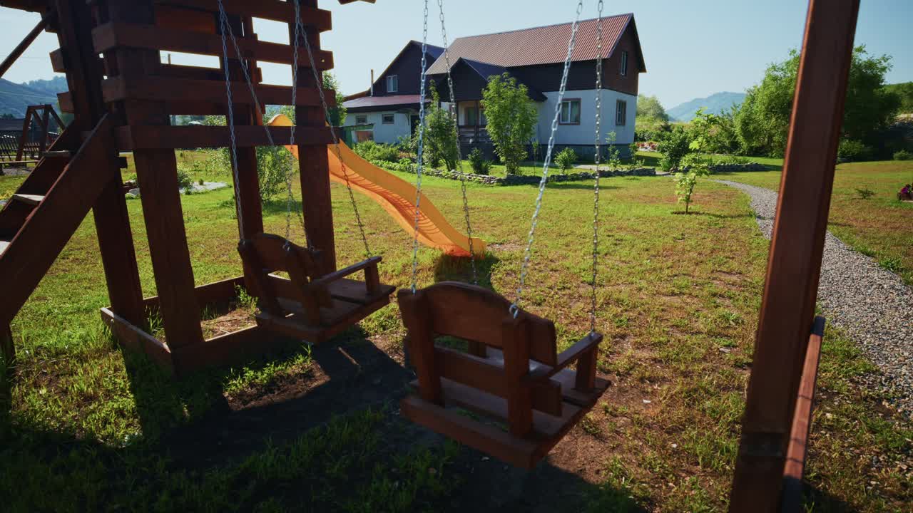 Empty Wooden Playground with Swings and Slide in Sunny Backyard