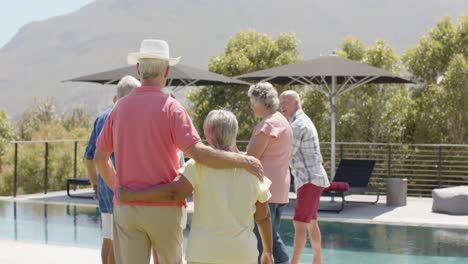 Happy-diverse-senior-friends-talking-and-embracing-at-sunny-garden-party,-unaltered,-in-slow-motion