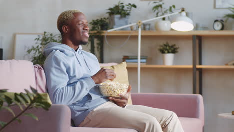 Black-Man-Eating-Popcorn-and-Watching-Comedy-Movie-at-Home