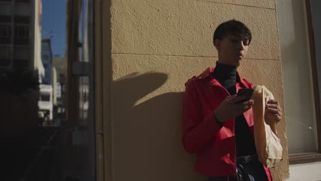 transgender adult eating a sandwich in the street