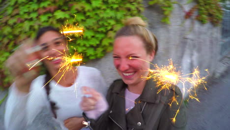 two women having fun with sparklers