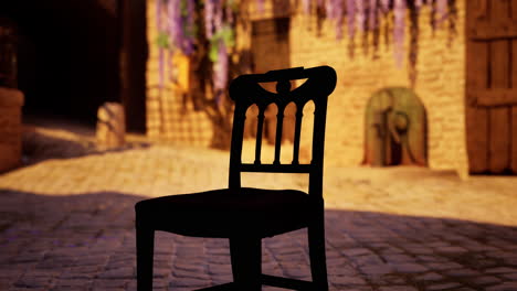 a solitary wooden chair sits in a medieval cobbled street