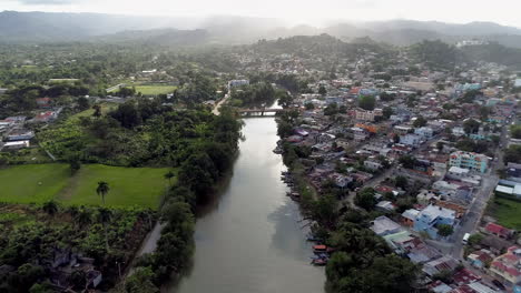 Drone-flying-over-Yeguada-river-and-panoramic-view-of-village