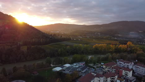 revealing sun aerial overview of tuscany province, italian countryside green vineyard-covered hills sunset on a cloudy day