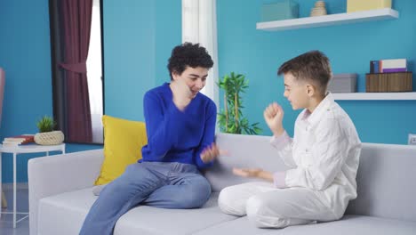 two boys playing rock, paper, scissors.