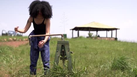 african girl pumping water pump for washing hands at rwanda africa