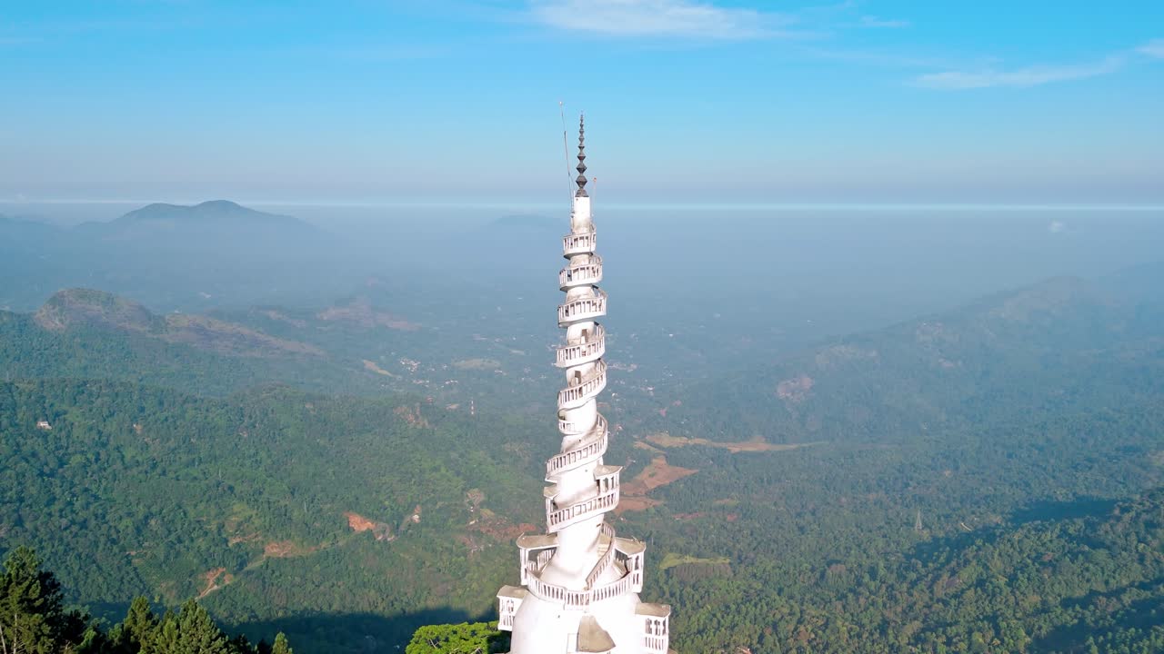 Experience the grandeur of Ambuluwawa Tower close to Kandy city at sunrise, captured from a drone.