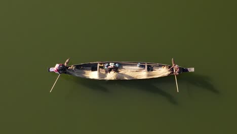 fisherman preparing fishnet on small wooden boat in bangladesh