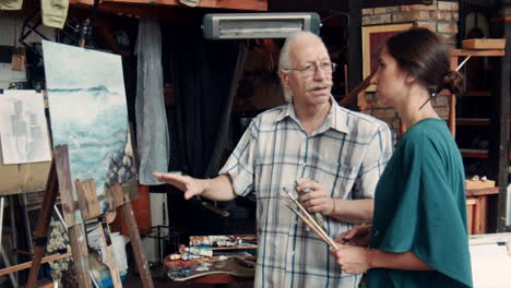 artist teaching a student in an art studio