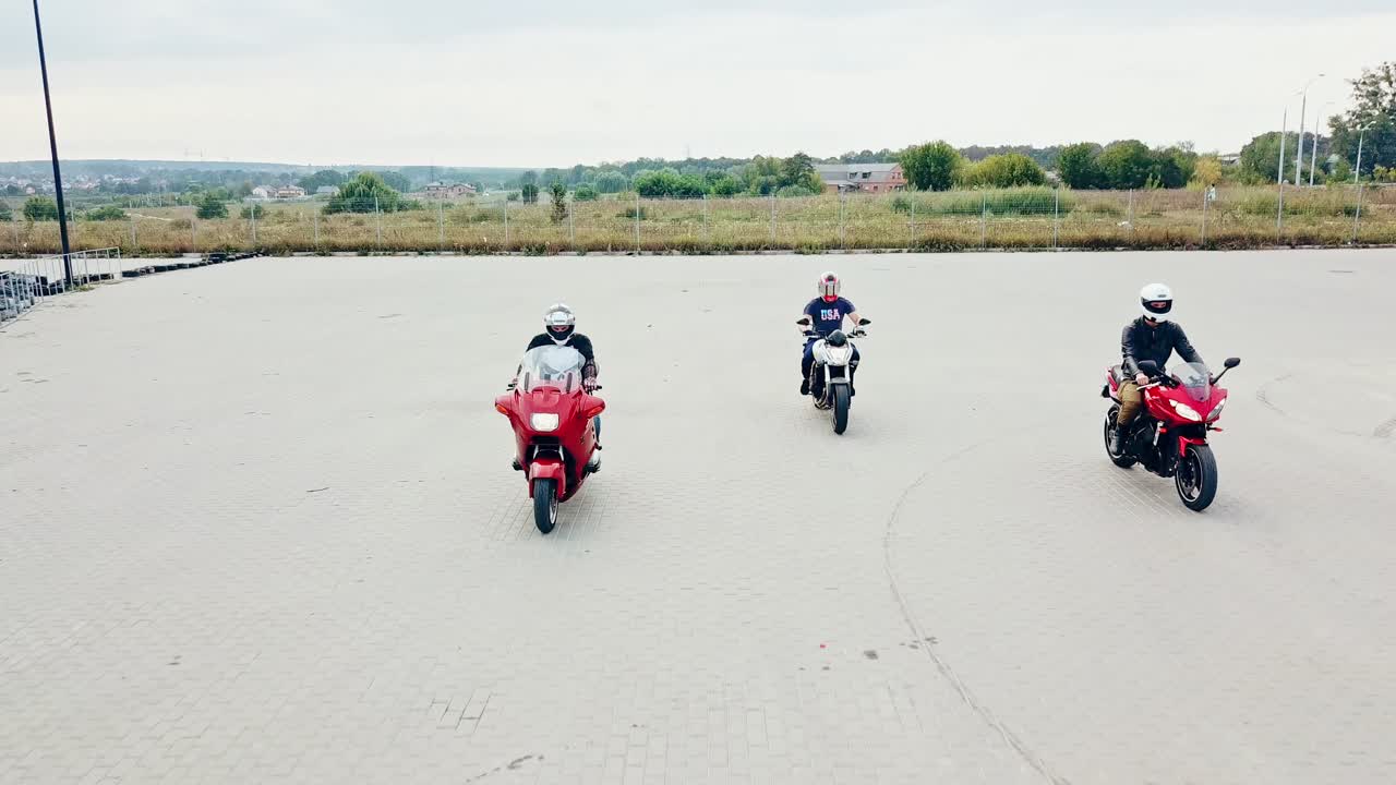 Bikers driving on motorcycle. Aerial view of drivers riding on motorcycle on empty asphalt road
